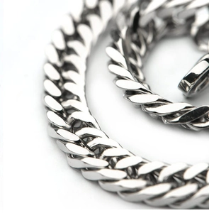 Macro shot of silver titanium steel Cuban chain link bracelet with polished metallic finish