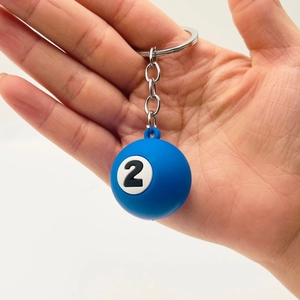 Blue number 2 billiard ball keychain with metal ring shown against white background