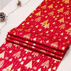 Christmas table runner with gold stamped trees and stars on red velvet fabric