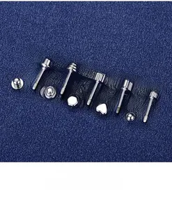 Macro detail of S925 sterling silver screw-back studs on textured blue fabric