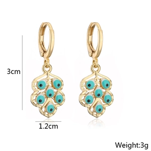 Detailed view of leaf-shaped gold earrings with blue evil eye charms and dimensions