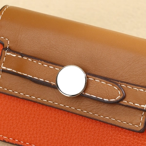 Detailed macro view of brown and orange lychee texture leather with white stitching