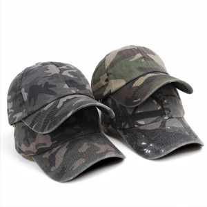 Close-up of assorted camouflage baseball caps showing durable canvas texture and stitching