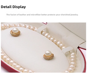 Macro view of oval leather jewelry box with pearl necklace and earrings set