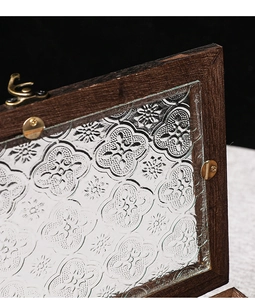 Detail of vintage wooden storage box with embossed pattern glass and brass latch