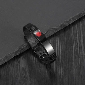 Macro detail of black stainless steel mesh medical alert bracelet with red Caduceus symbol
