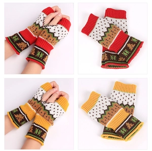 Close-up of knit fingerless gloves with Christmas tree and snowflake patterns in red and yellow