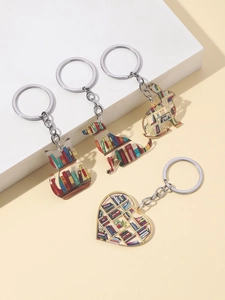 Close-up of four acrylic graduation keychains featuring cute animals and bookshelf patterns