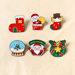 Set of six Christmas enamel pins featuring Santa Claus and reindeer on a beige background