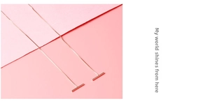 Detail view of rose gold S925 sterling silver tassel threader earrings with sleek bar end