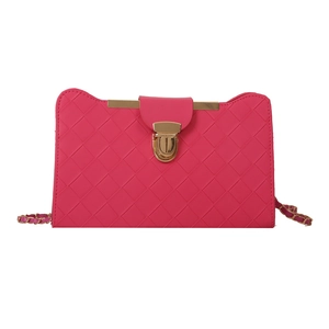 Minimalist woven texture rose red handbag with gold buckle and chain strap on white background