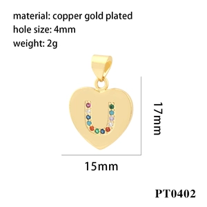 Detail of 18K gold plated heart charm with U-letter colorful cubic zirconia stones
