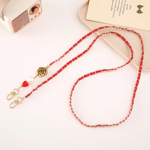 Detail of red leather woven chain with gold heart charm and rose accent for phone straps