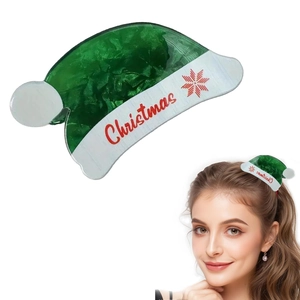 Detail of green and white Christmas hat hair claw clip with snowflake and logo patterns