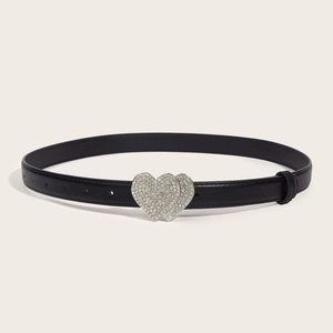 Women's black leather belt with silver sparkling double heart buckle on beige backdrop