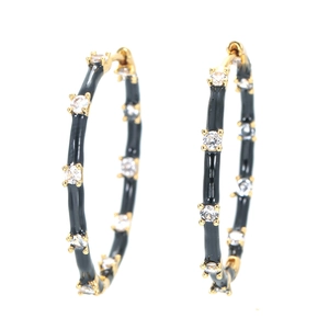 Chunky gold hoop earrings with black enamel coating and sparkling zircon accents