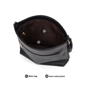 Detail view of the black leather tote bag featuring a brown lining and interior pockets