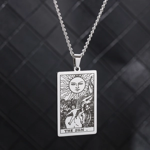 Macro shot of The Sun Tarot card pendant in vintage silver stainless steel on rope chain