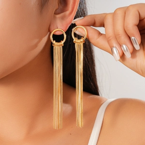 Elegant 18K gold plated long tassel drop earrings worn by a model in a close-up view