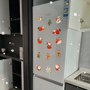 14-piece Christmas magnets set with Santa and Gingerbread Man on a white fridge door