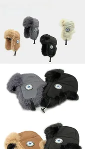 Detail of four thermal trapper hats with thick faux fur lining and winter sports badges