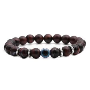 Detail view of 8mm tiger eye beads and blue evil eye charm with silver spacers