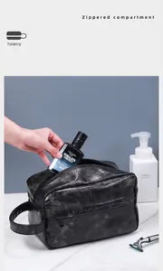 Close-up of black PU leather toiletry bag showing side handle and zippered compartment