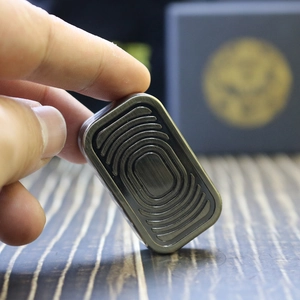 Macro detail of the brushed metal surface and wave texture of this EDC fidget slider toy