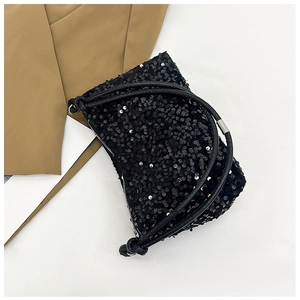 Detail view of the black sequined hobo bag with zip closure and knotted handle