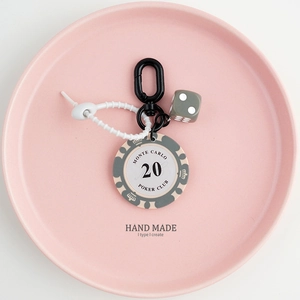 Close-up of Monte Carlo poker chip keychain with silicone strap and lucky dice