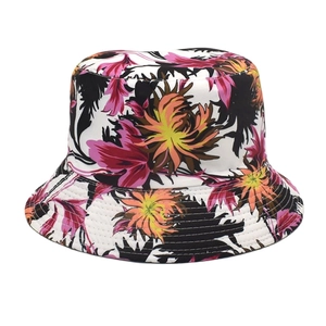 Detail showing the colorful floral print and fine stitching on the white cotton bucket hat