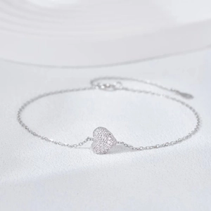Detail shot of a S925 sterling silver heart bracelet with sparkling zircon stones