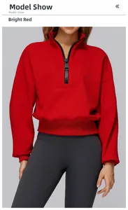 Detail of red half-zip hoodie featuring metal zipper and adjustable drawstring cords
