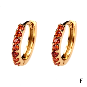 Close-up of 18K gold plated hoop earrings set with two rows of orange cubic zirconia