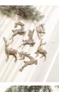 Macro detail of glitter reindeer ornaments with champagne finish and ribbon bows