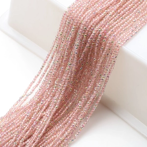 Macro shot of 2mm light pink faceted glass beads with AB coating for DIY jewelry