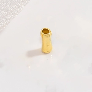 Close-up of golden bamboo shaped S925 sterling silver tube bead for DIY jewelry making