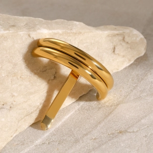 Close-up of a U-shaped 18K gold polished stainless steel hair pin on natural stone