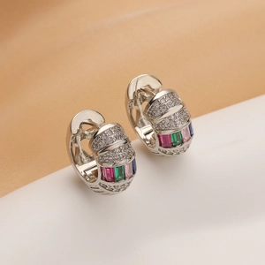 Macro shot of silver plated earrings with multicolor zircon and pavé crystals