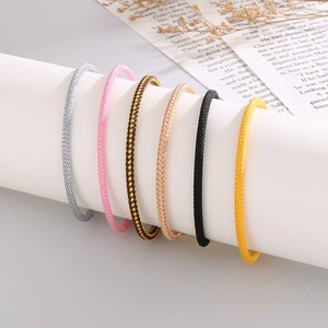Detailed view of six colors of braided nylon rope bracelets on a cylindrical display stand