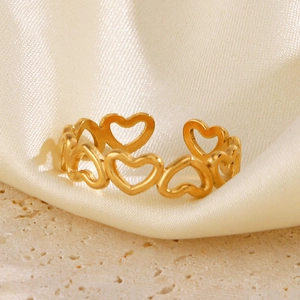 Minimalist hollow heart gold-plated stainless steel ring on silk and stone background