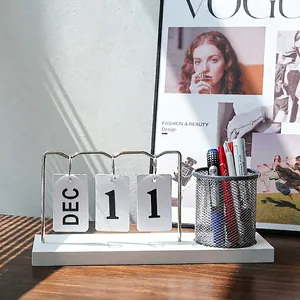 Minimalist white desktop calendar with metal ring binder and black mesh pen holder