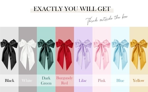 Selection of eight colorful satin hair bows with long ribbons and smooth texture