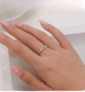 Close-up of S925 sterling silver open ring with teardrop zircon worn on model's hand