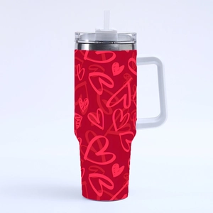 Detail of red 40oz heart pattern tumbler with white handle and straw, macro view