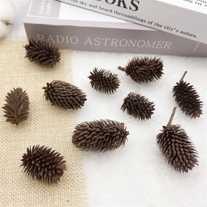 Flat lay of natural pine cones on white fur and burlap background for rustic decor