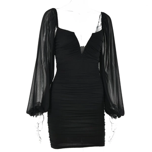 Detail of black V-neck mini dress showing mesh lantern sleeves and ruched fabric texture