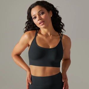 Detail showing seamless ribbed fabric texture on black fitness sports bra and leggings