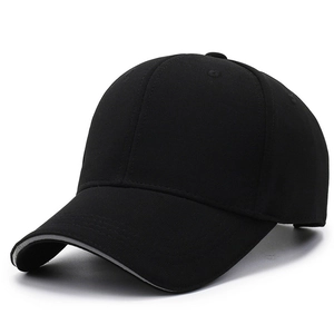 Black baseball cap with reflective strip and textured fabric on a white background