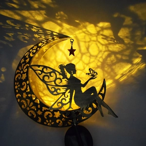 Close-up of a crescent moon solar light casting a fairy shadow with warm glow